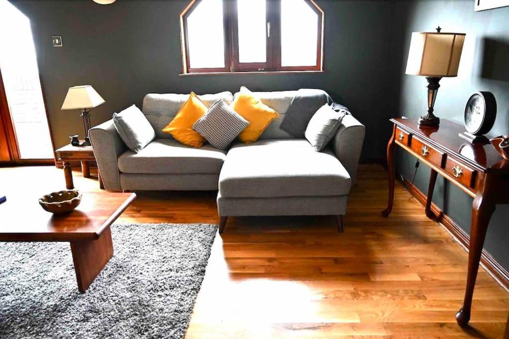 a living room with a couch and a table at Water view Apartment in Belfast