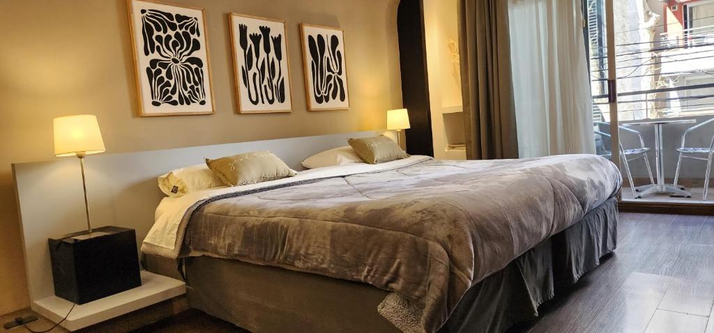 a bedroom with a large bed with two pillows at Studio FR Palermo Hollywood in Buenos Aires