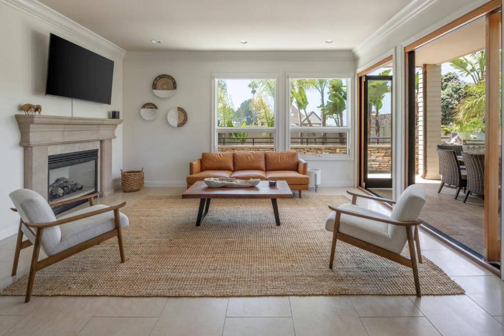a living room with a couch and a fireplace at Ocean View Del Mar Beach Home w Jacuzzi in San Diego