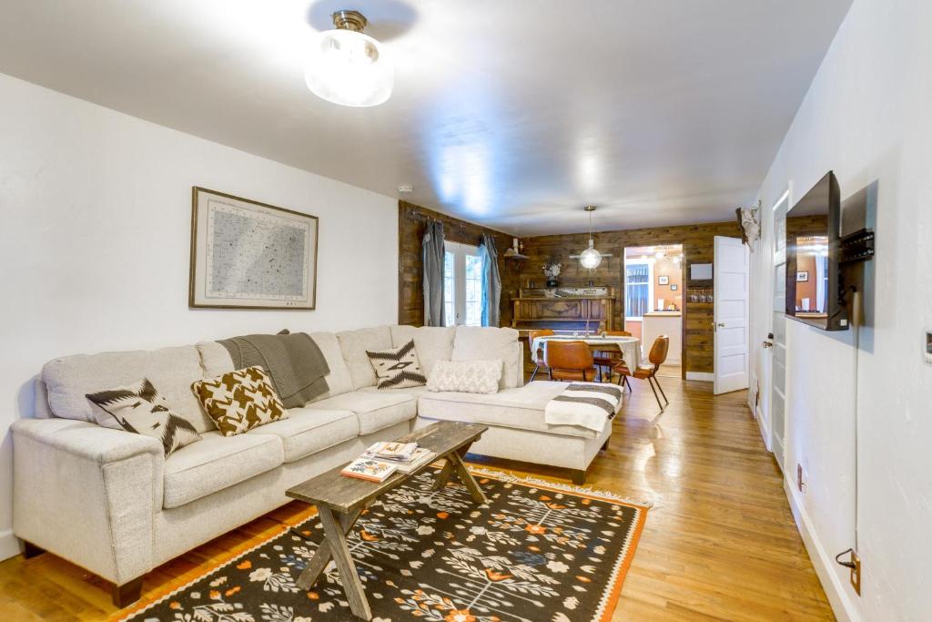 a living room with a couch and a table at Charming Denver Home Outdoor Oasis with Grill in Denver