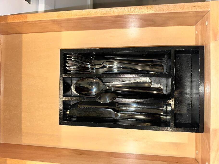 a drawer with utensils in a wooden box at Home Haven, Walk to Little Italy & Wooster Square in New Haven