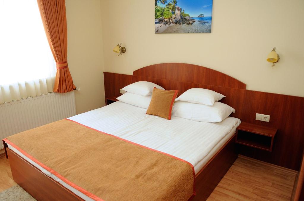 Postel nebo postele na pokoji v ubytování Apartman Bella Hotel