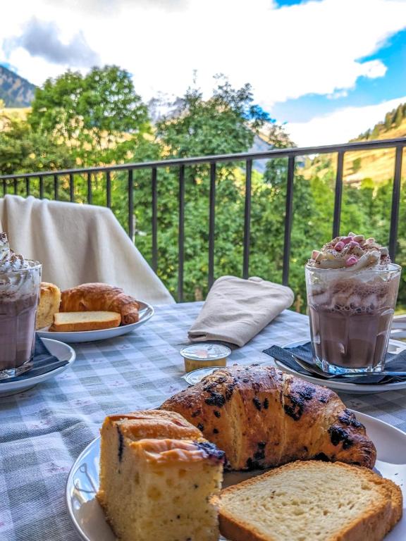 a table topped with plates of bread and pastries at Rifugio Aleve in Castello