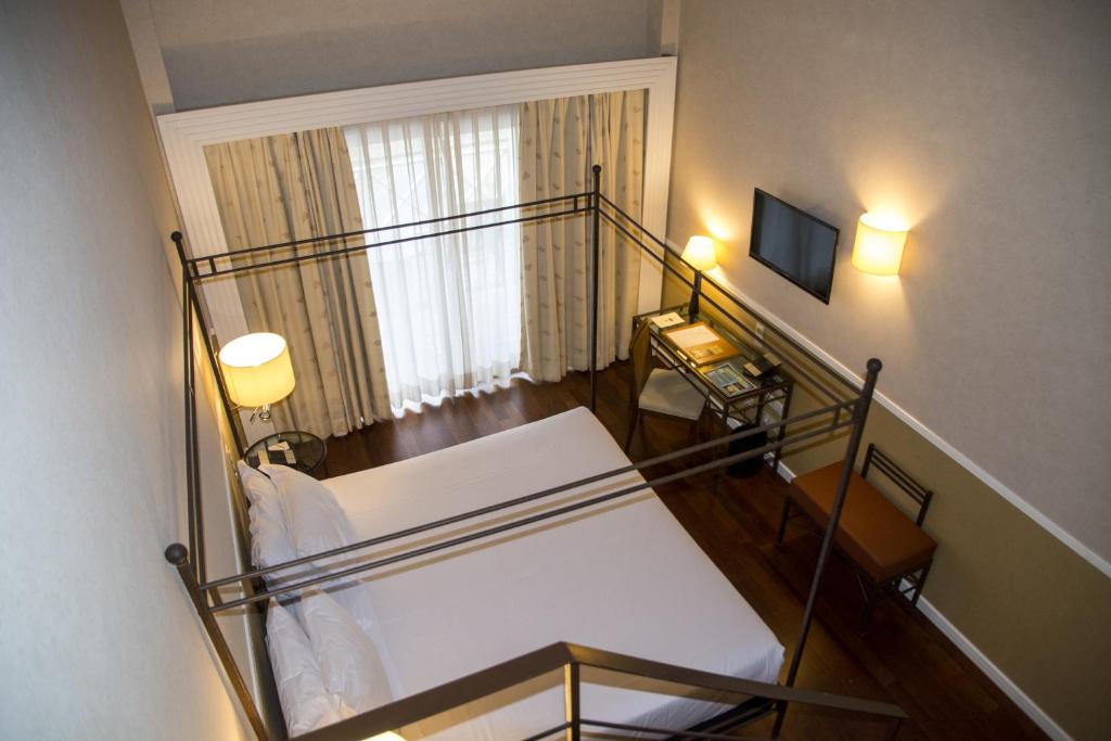 a bedroom with a bunk bed and a stair case at Hotel Nuevo Portil Golf in El Rompido