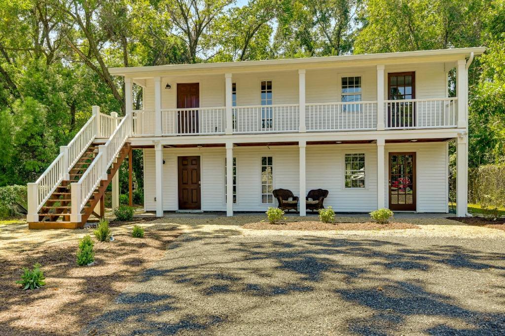 a large white house with a porch and stairs at Charming Apartment in Downtown Georgetown! in Georgetown