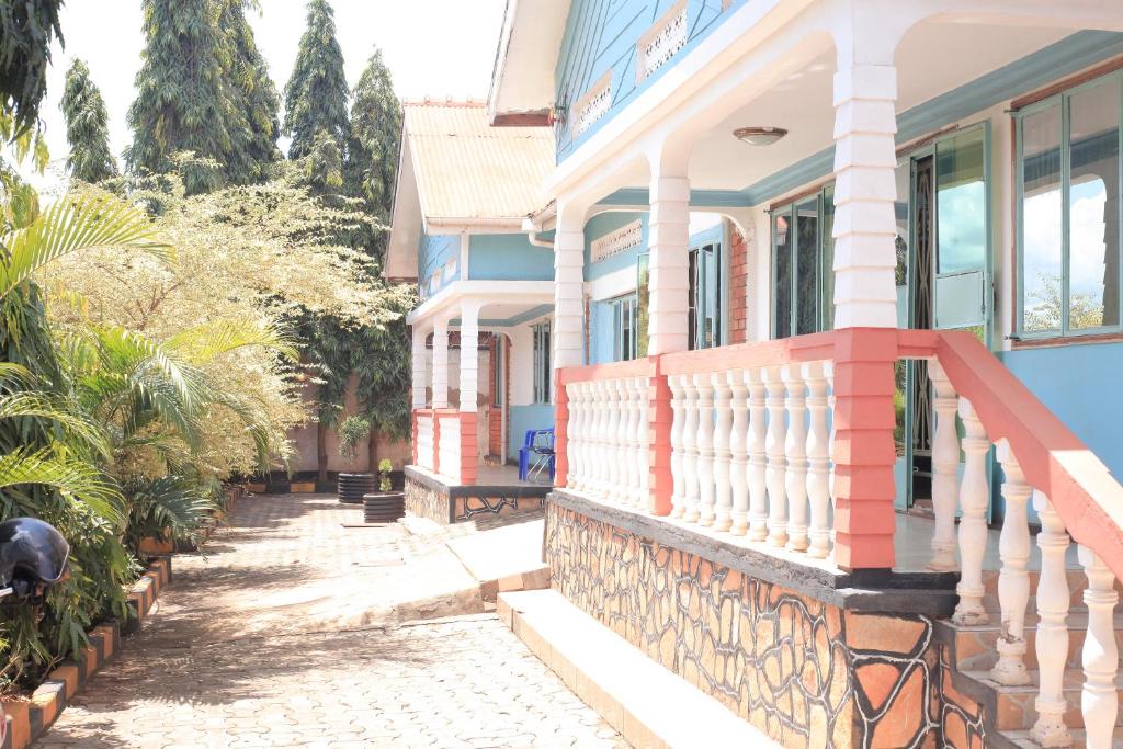a blue and red house with a balcony at Emmas' Guest House in Kampala