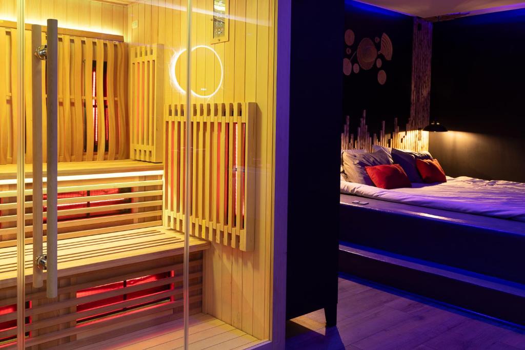 a room with a bed in a room with lights at UNE PARENTHESE ARDENNAISE in Charleville-Mézières