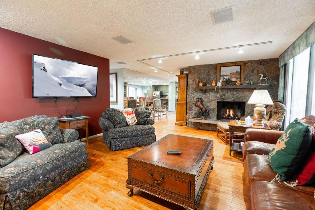 a living room with couches and a fireplace at Scorpio Condominiums by Vail Realty in Vail