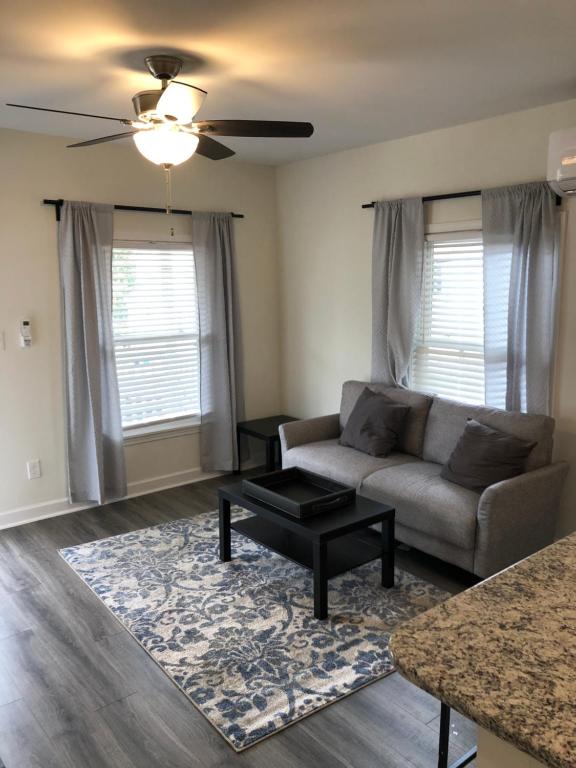 a living room with a couch and a table at Lakewoodlyon Park Renovated Cottage Near Duke 23b in Durham