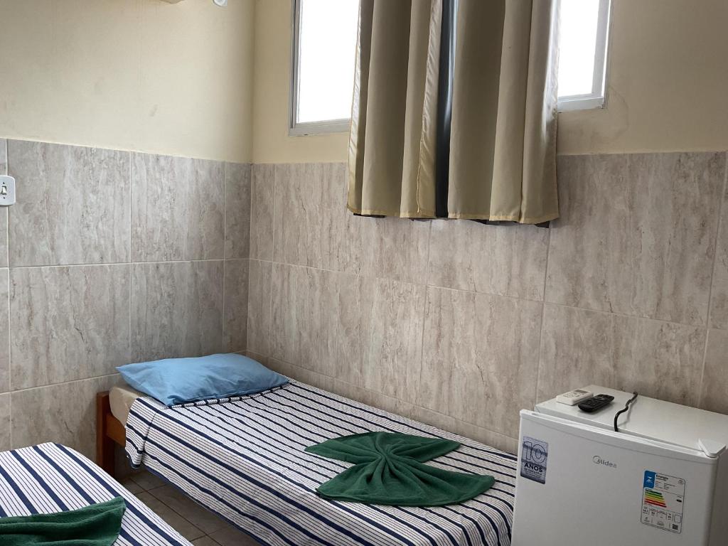 Postel nebo postele na pokoji v ubytování Pousada Pitanga