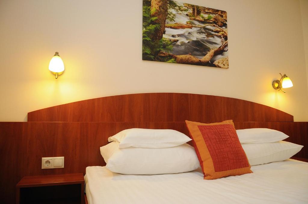 Postel nebo postele na pokoji v ubytování Apartman Bella Hotel