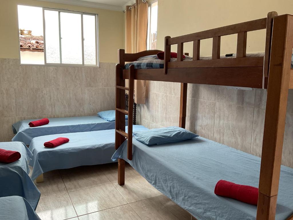 a room with three bunk beds in it at Pousada Pitanga in Maceió