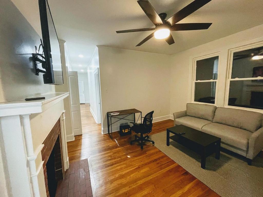 a living room with a couch and a ceiling fan at Renovated 1 Bedroom In Forest Hills - A in Durham
