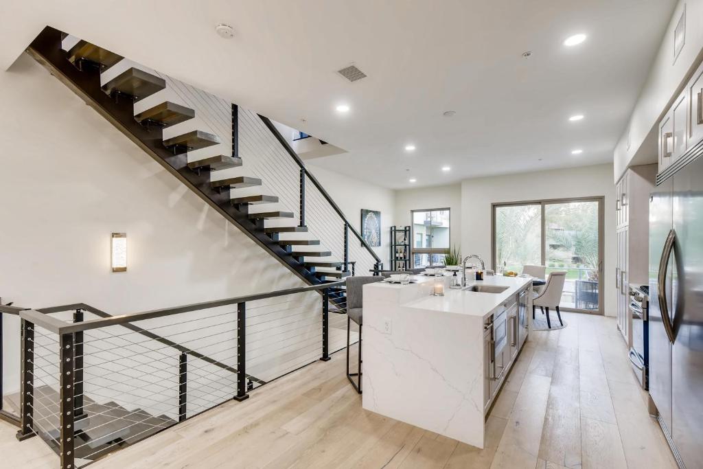 a kitchen and dining room with a spiral staircase at Parkway Paradise in Scottsdale