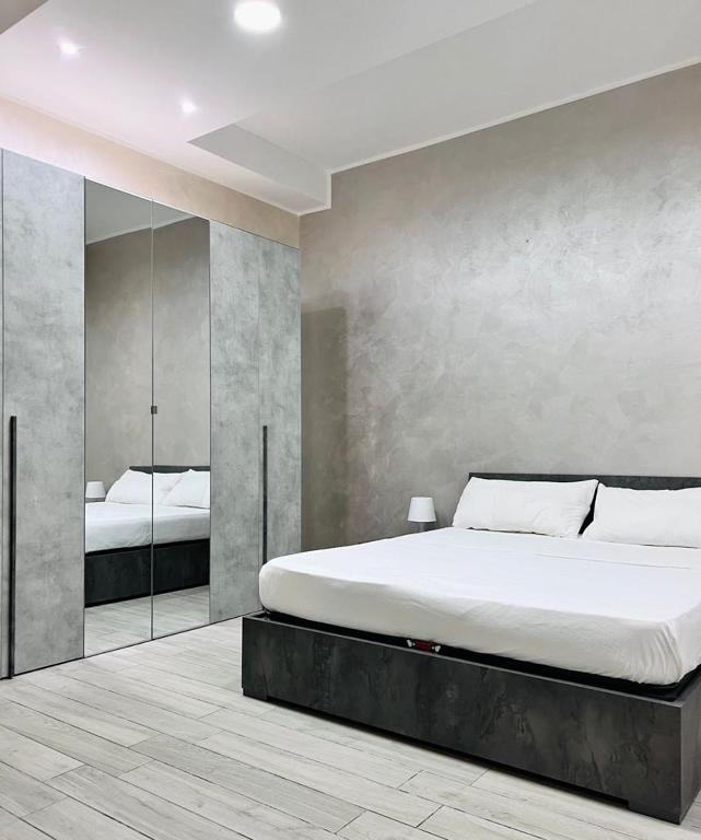 a bedroom with a large bed and a mirror at Lady Luxury Apartment in Bari