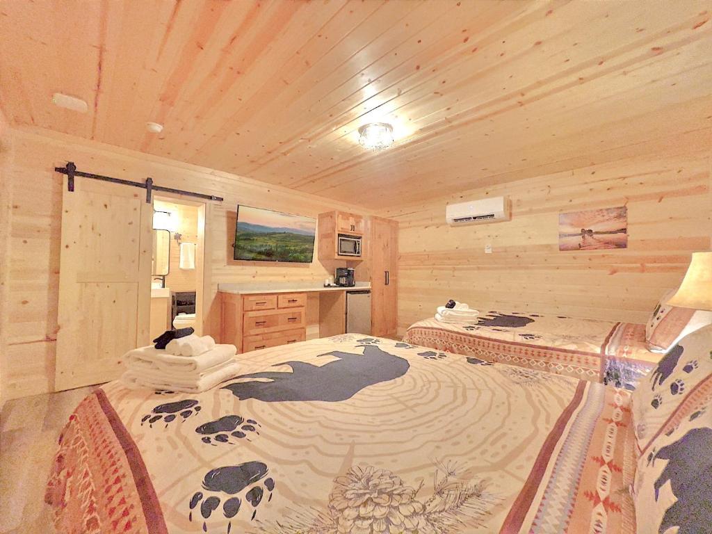 a bedroom with a large bed in a log cabin at Retreat on the Lake in Hiawassee