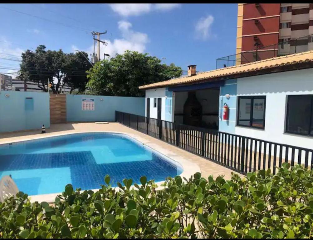 a swimming pool in front of a house at Ap. Espetacular. À 5 minutos da praia. in Aracaju
