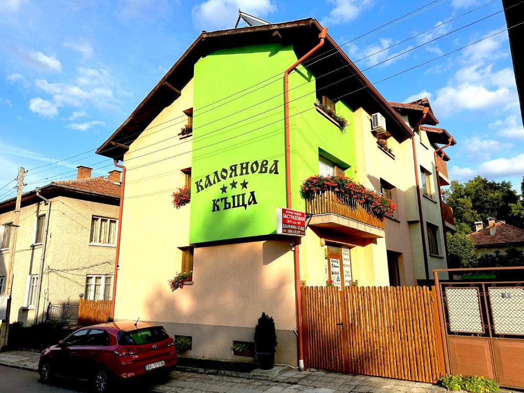 a building with a sign on the side of it at Kaloyanova House Bansko in Bansko