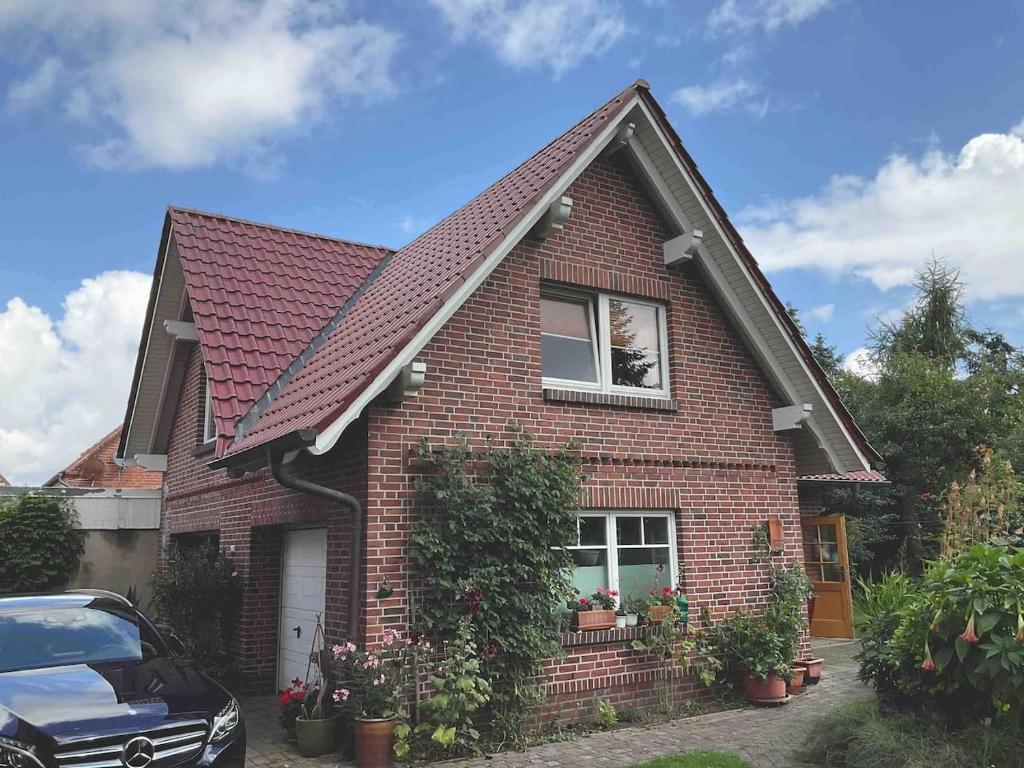 a brick house with a red roof at Idyllische Dachgeschosswohnung in Wittenburg