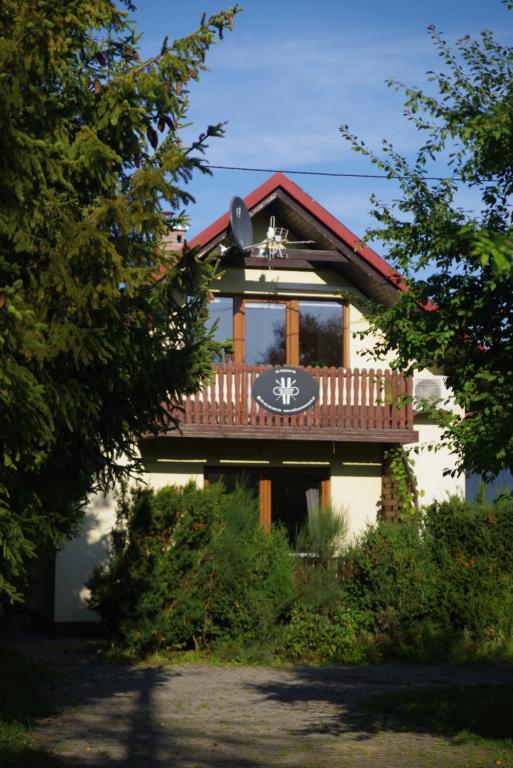 a house with a balcony on top of it at Ski House Szczyrk - Centrum in Szczyrk