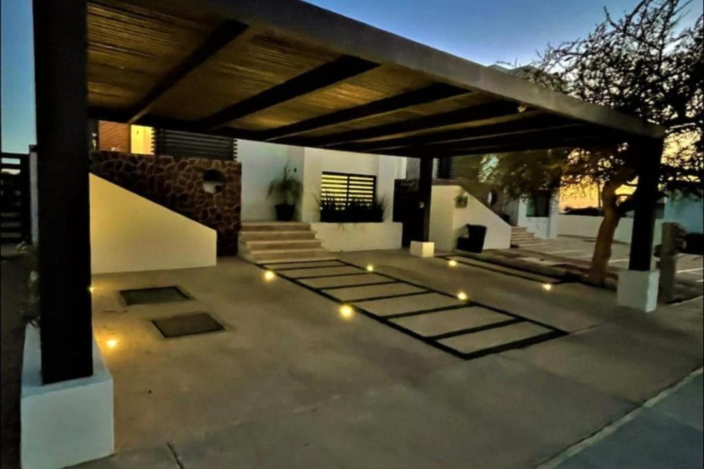 a patio with a roof with lights on it at Apartamento en Cabo San Lucas México in Cabo San Lucas
