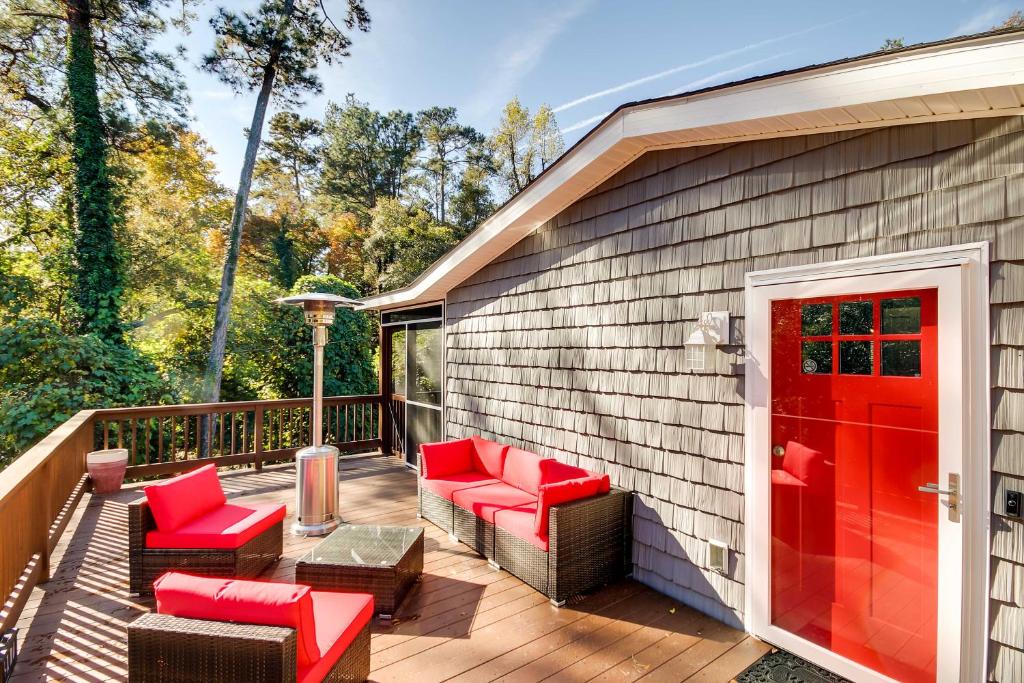 a deck with red chairs and a red door at Step-Free Home with Fire Pit - 3 Miles to USC! in Columbia