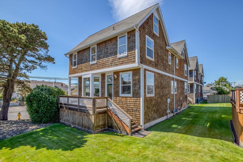 a large brick house with a porch and a yard at Seaside Vacation Rental in Seaside