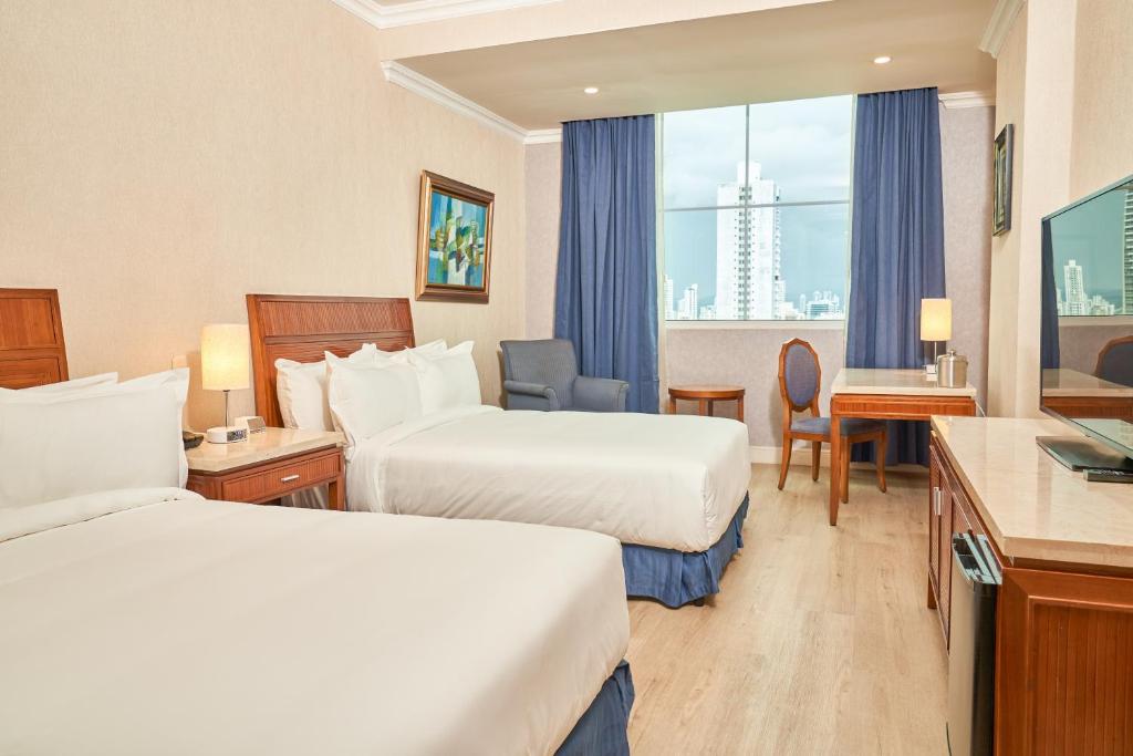 Postel nebo postele na pokoji v ubytování Waymore Hotel Spa & Casino