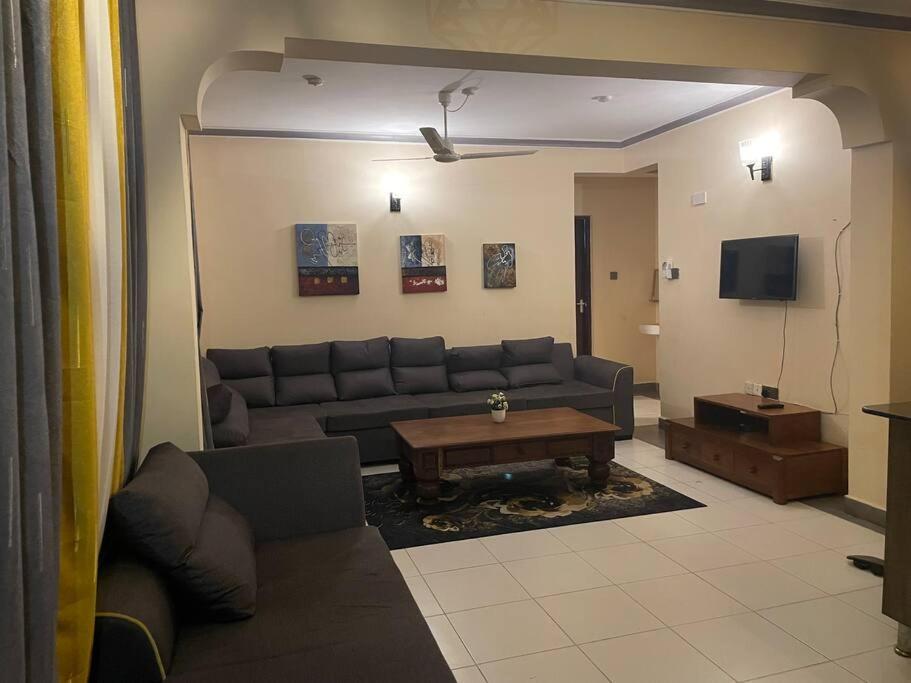 a living room with a couch and a table at The Tropics Apartment Mombasa in Mombasa