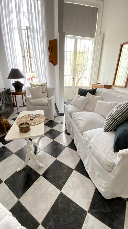 a living room with a couch and a checkered floor at V.60 in Nueve de Julio