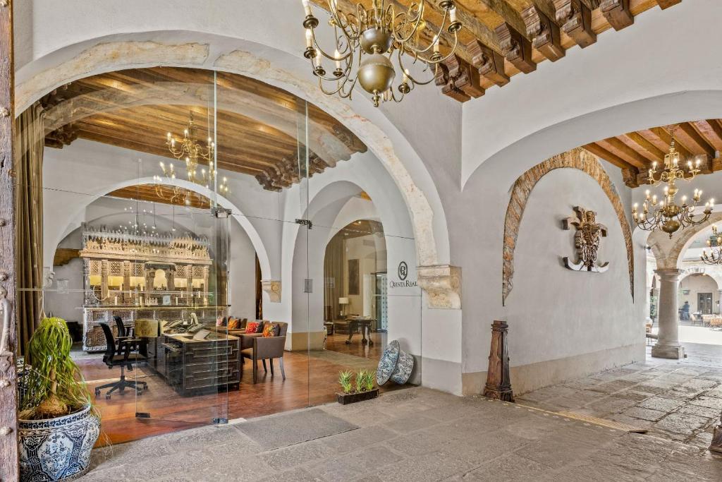 a living room with a chandelier in a building at Quinta Real Puebla in Puebla