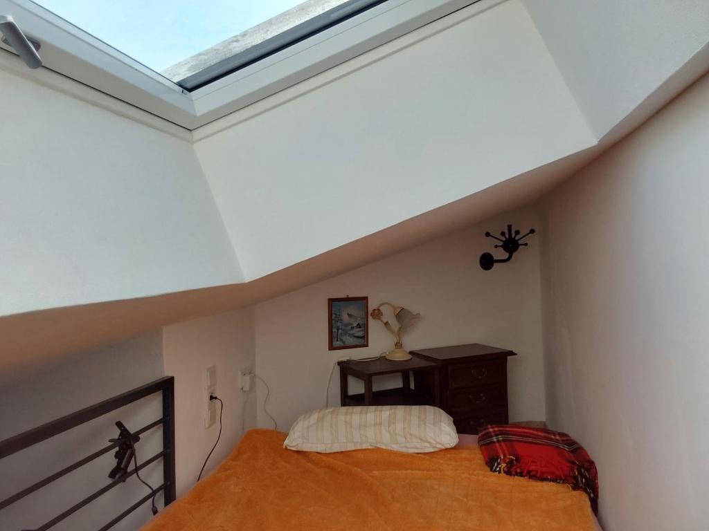 a bedroom with a bed and a skylight at 3 seperate APARTMENTS - 1,5 room apt - 2,5 rooms apt - 3,5 rooms apt mit sauna and kamin in Munich