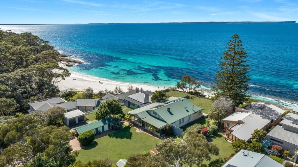 an aerial view of a house and the beach at Pacific Lodge in Hyams Beach