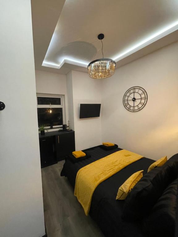 a bedroom with a bed and a chandelier at RESIDENCY LUXURY SEAFRONT HOTEL in Blackpool
