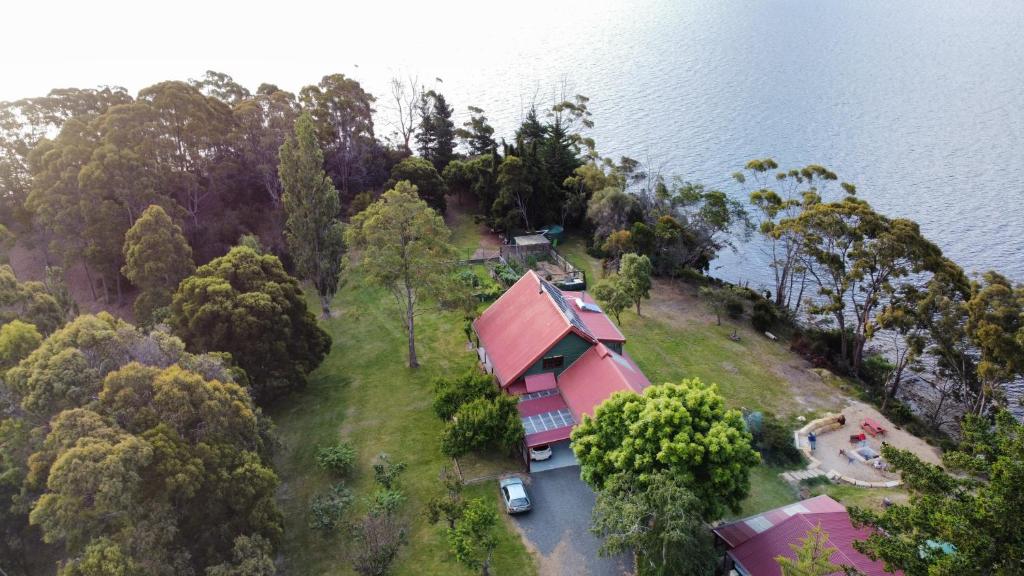 an aerial view of a house on an island in the water at Tranquil Point in Cygnet