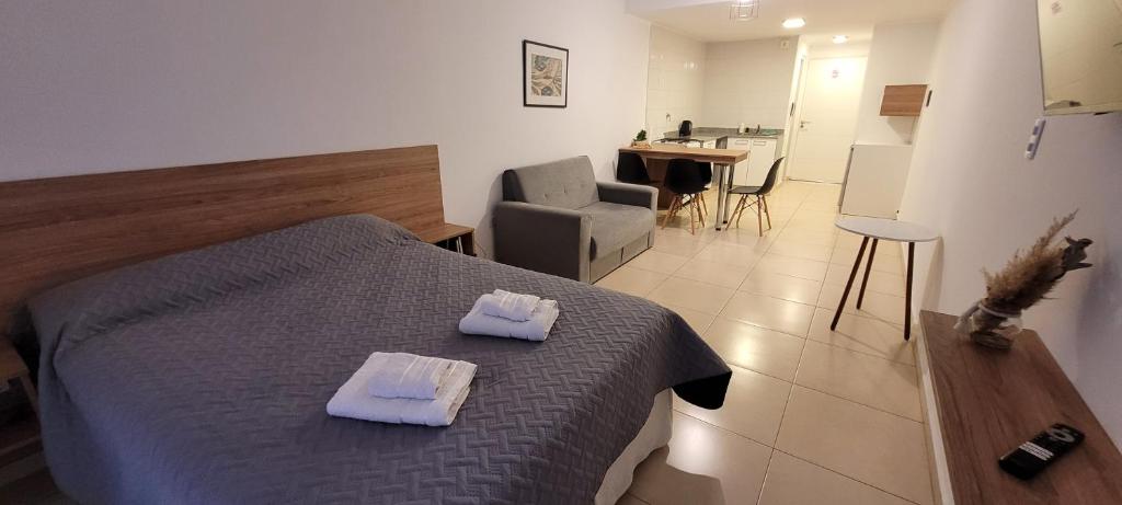 a bedroom with a bed with two towels on it at Edificio 9 de Julio in San Miguel de Tucumán