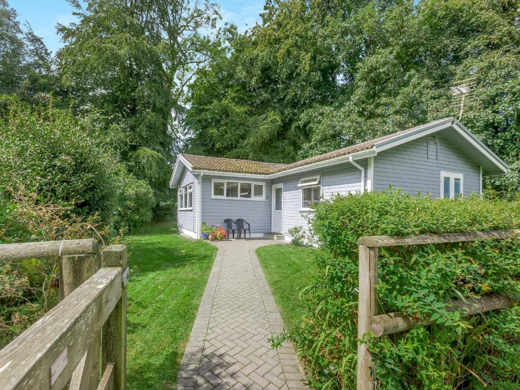 a house with a fence in front of it at Keepers Wood - W43109 in Bradworthy