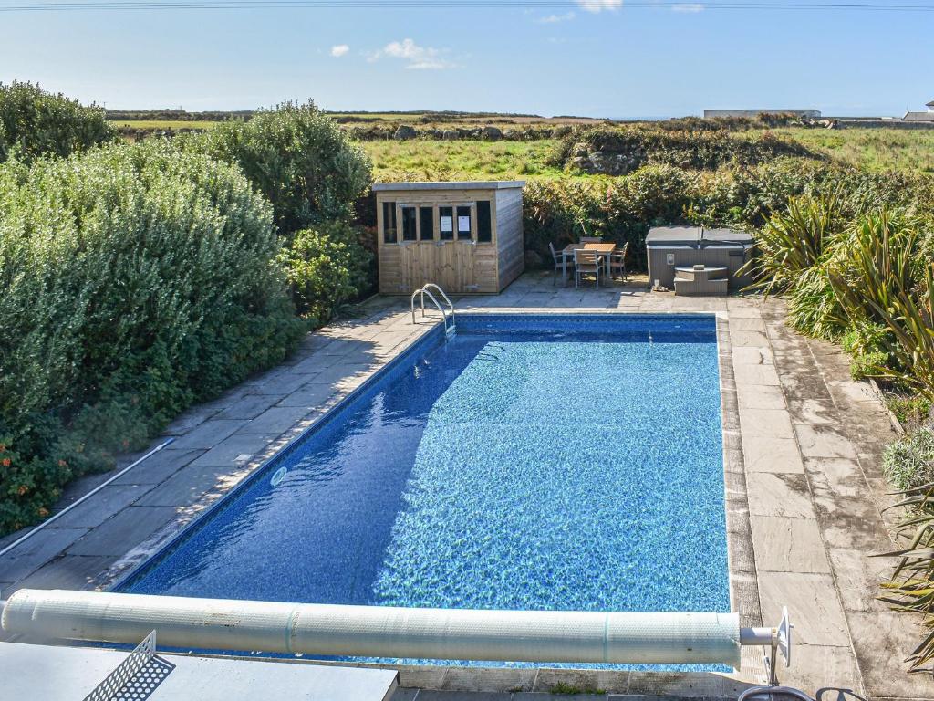 a swimming pool in the yard of a house at No Place in Sennen