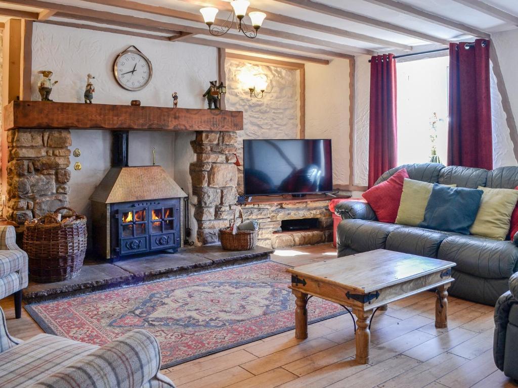 a living room with a couch and a fireplace at Stoneybeck-uk45044 in Greenhead