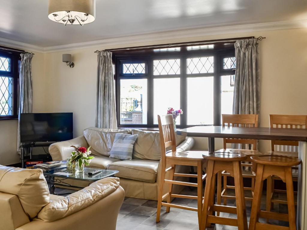 a living room with a couch and a table at The Granary - Uk45181 in Newcastleton