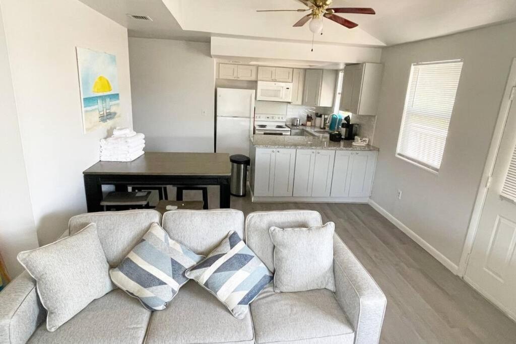 a living room with a couch and a kitchen at Tropical Retreat in Clearwater Beach