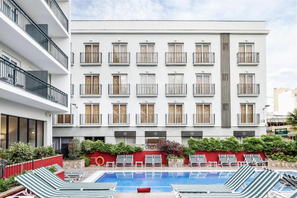 an image of a hotel with chairs and a swimming pool at AQUA Hotel Bertran Park in Lloret de Mar