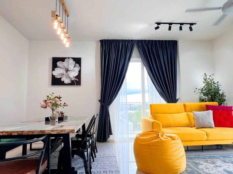 a living room with a yellow couch and a table at Spacious 6PX 3BR, Verdi @ Cyberjaya Near KLIA & KLIA2 in Cyberjaya