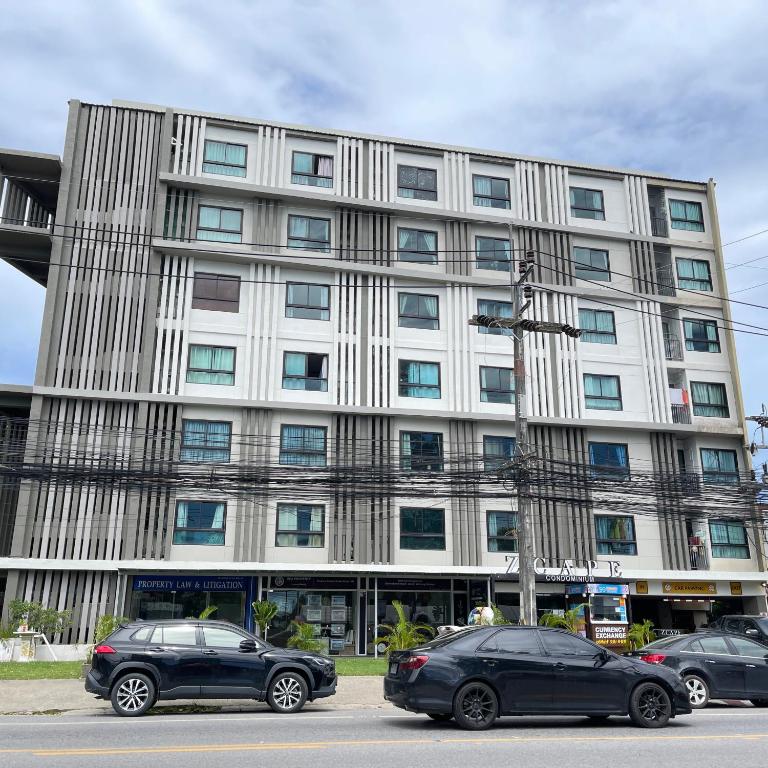 two cars parked in front of a building at Zcape at Bangtao in Bang Tao Beach
