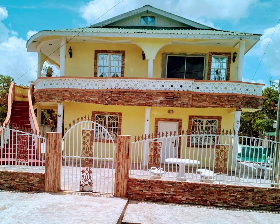 a house with a white fence in front of it at Charming 1-Bed House in Georgetown in Georgetown