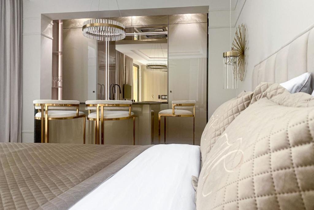 a bedroom with a bed and a sink and a mirror at Monaco Premium Suites - NEW in Monte Carlo