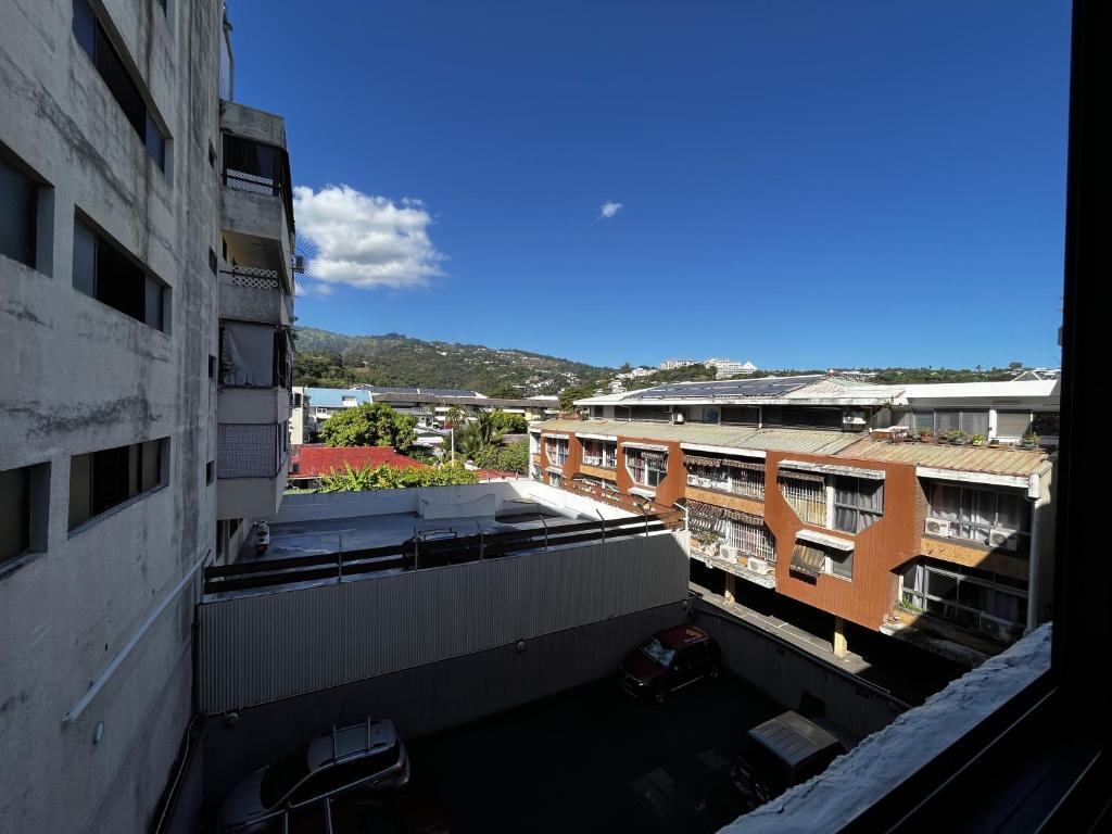 an overhead view of a parking lot between buildings at NEW My Lodge - Parking, AC, Netflix & Wifi in Papeete