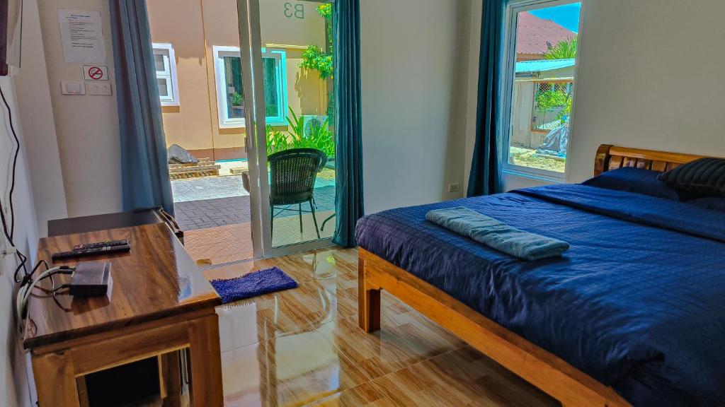 a bedroom with a bed and a table and a mirror at The 99 House in Jomtien Beach