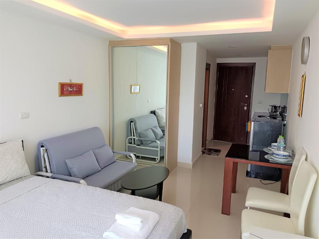 a room with a bed and a chair and a table at Laguna Beach Resort 3 Maldives in Jomtien Beach