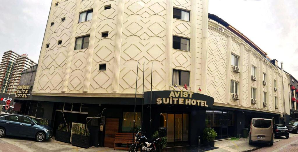 a building on a street with a car parked in front at Avist Hotel Avcılar in Avcılar